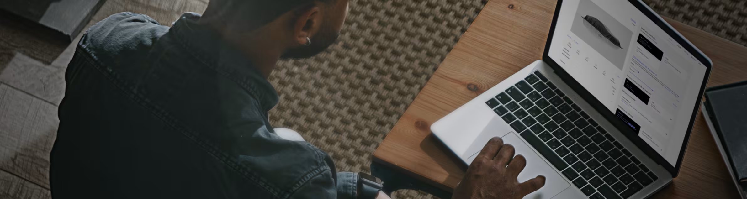 man sat at table with computer