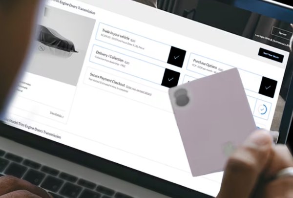 person holding a card on the computer