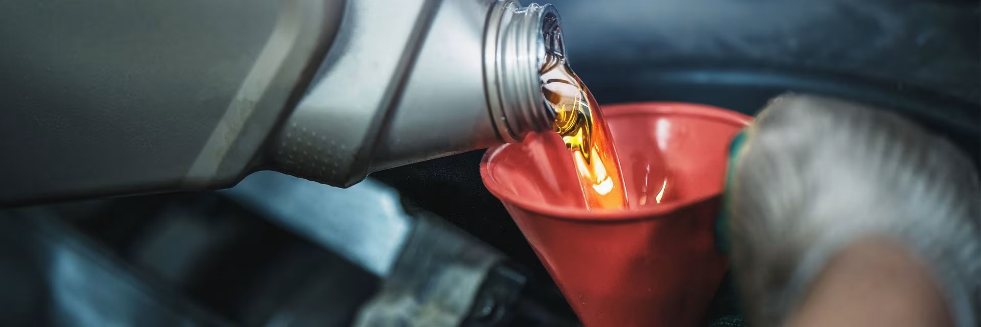 oil being poured down funnel