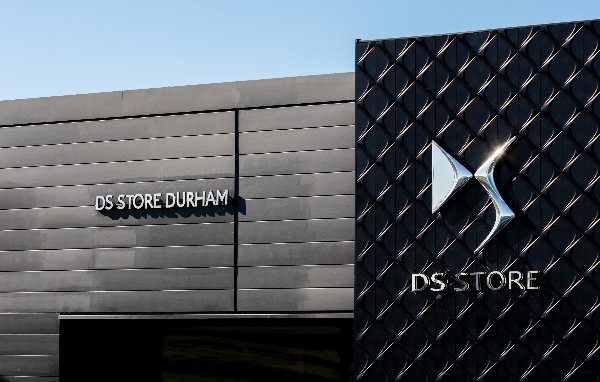 DS Store Durham sign on modern black building façade.