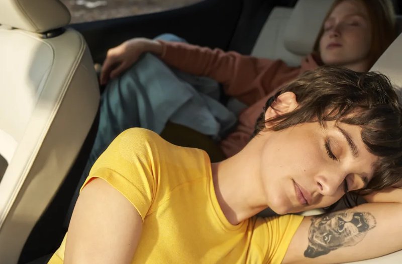 Two people sleeping in the car