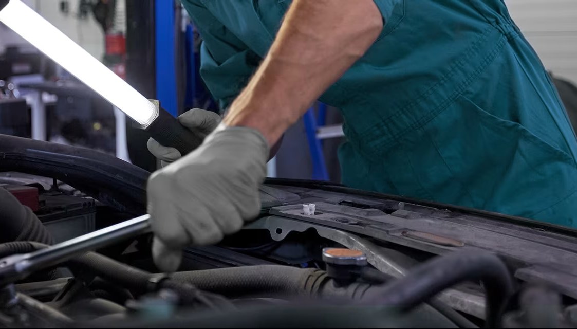 person looing under car bonnet