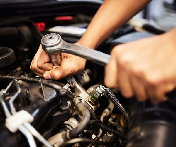 erson, hands and mechanic with spanner for fixing engine and motor maintenance in