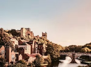 Riverside view of Durham city with Durham Cathedral and Castle on the hill.