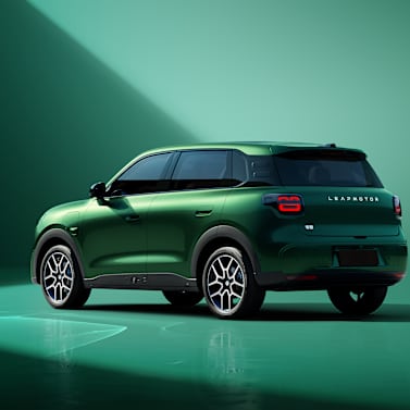 Green SUV viewed from the rear side angle.