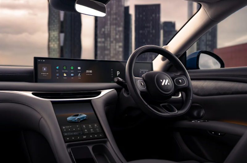 shot of the steering wheel of a car with city in the background