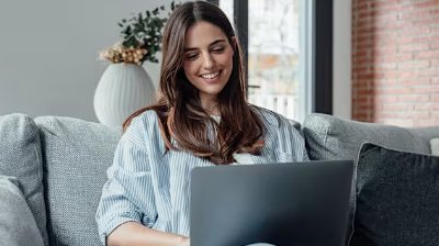 woman on laptop on the sofa