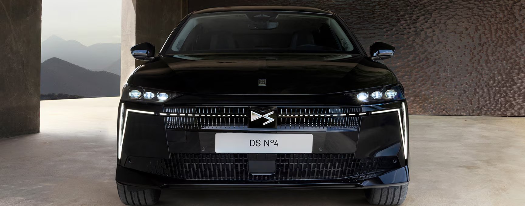 front of the car parked within a modern bronw building