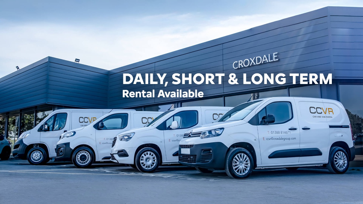 Four white vans parked outside Croxdale building with rental services text.