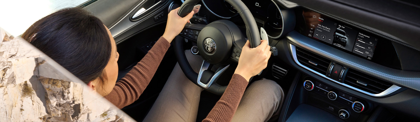 high shot of the car with woman sitting in the front seat